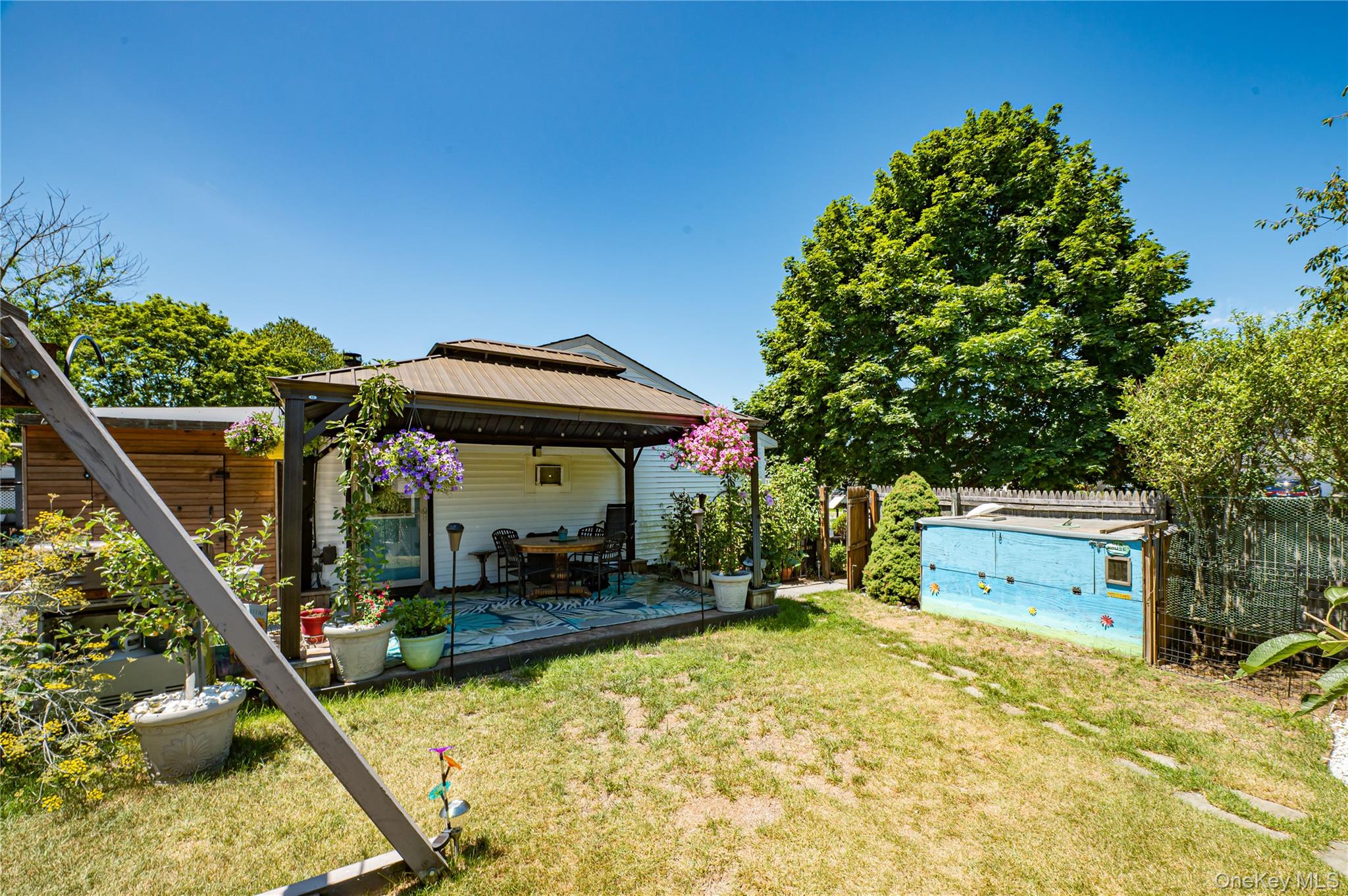 8 Woodbrook Drive, Unit 8 Ridge, NY 11961 - Photo 28 of 30 a house view with a backyard space