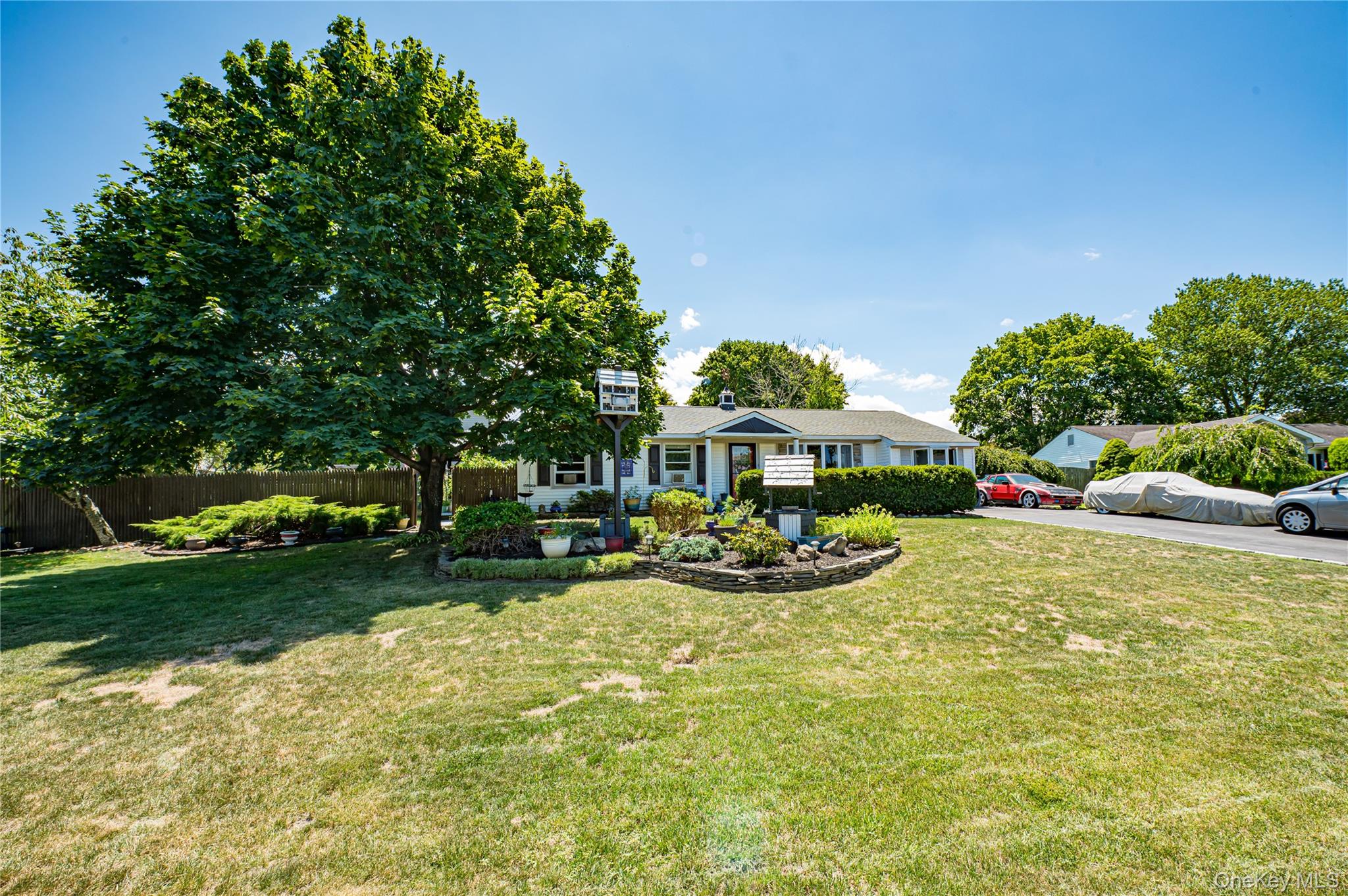 8 Woodbrook Drive, Unit 8 Ridge, NY 11961 - Photo 3 of 30 a view of a chair and tables in the garden