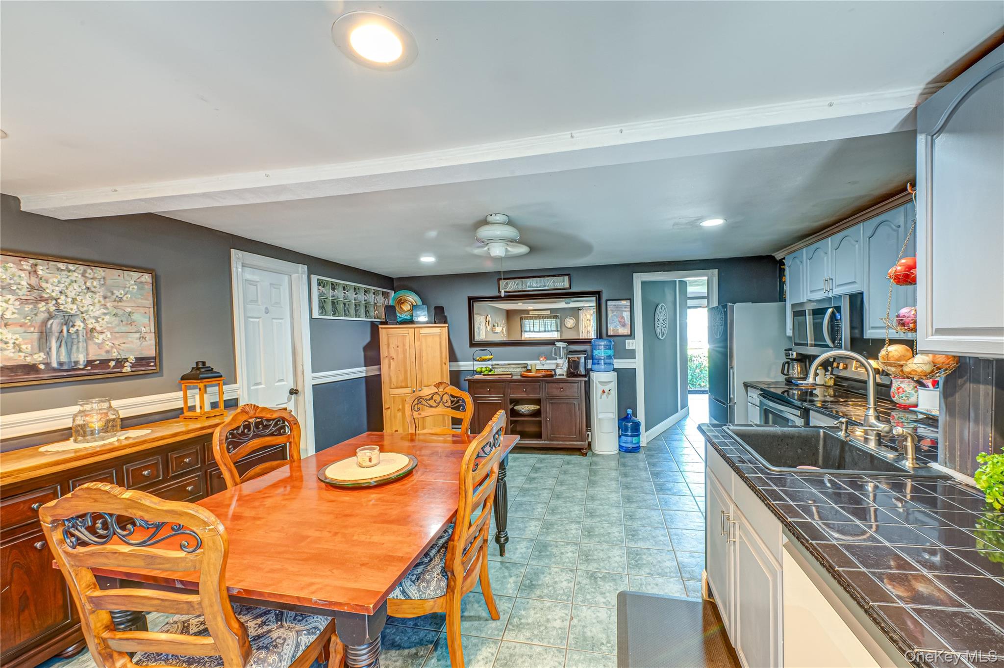 8 Woodbrook Drive, Unit 8 Ridge, NY 11961 - Photo 8 of 30 a kitchen with stainless steel appliances granite countertop a stove a sink and a refrigerator