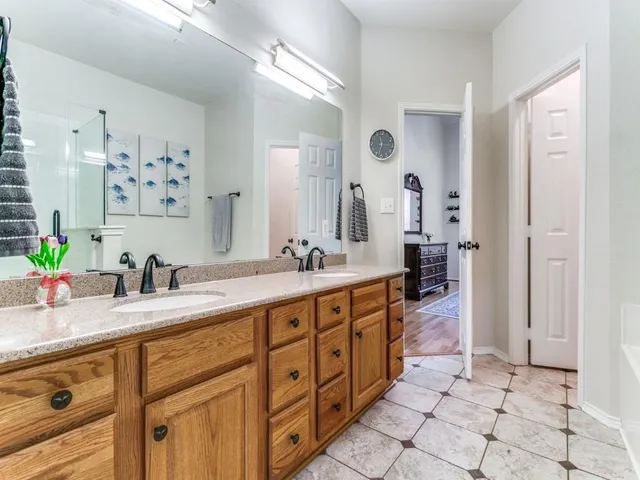 a spacious bathroom with double sink and a mirror