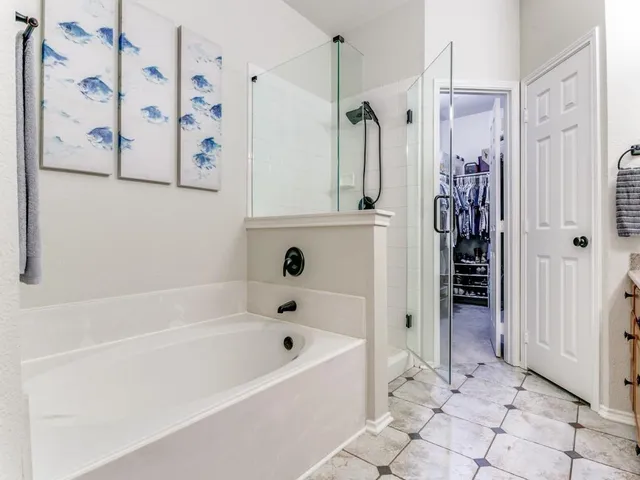 a bathroom with a bathtub and a shower