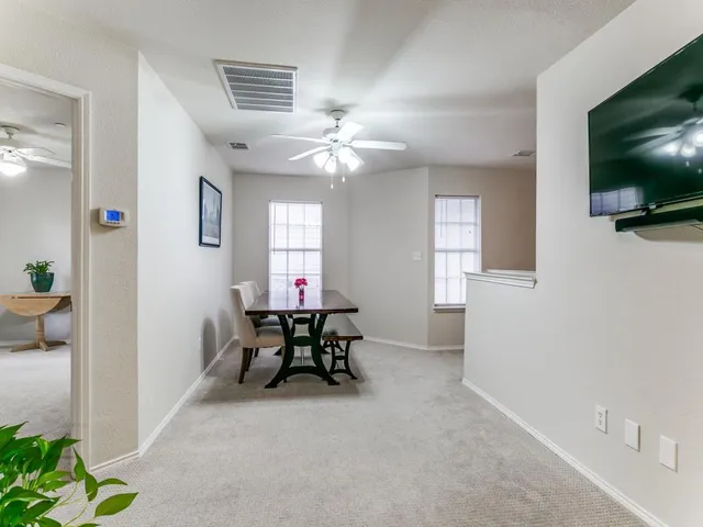 a view of a livingroom with furniture and a flat screen tv