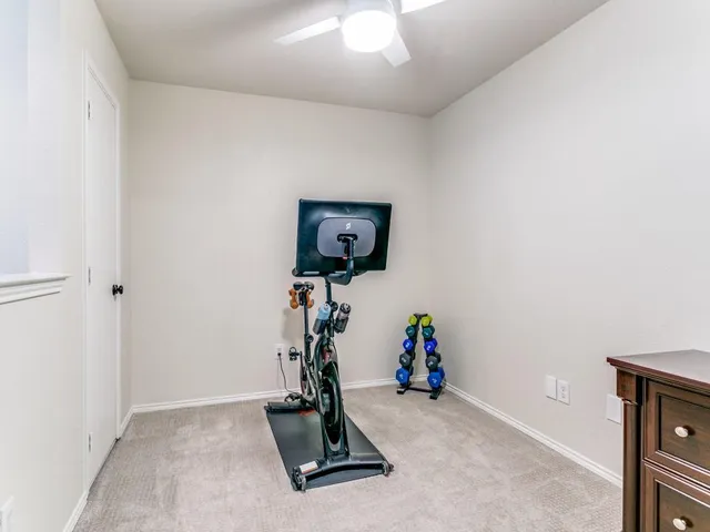 an empty room with gym equipment and a mirror