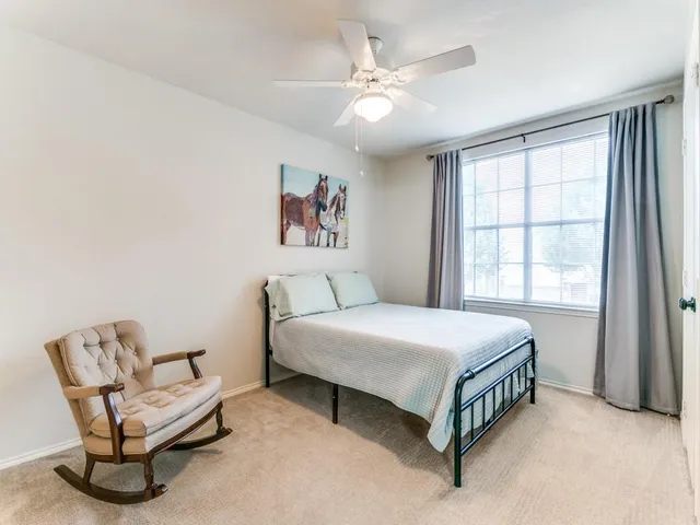 a bed room with a bed and a chair