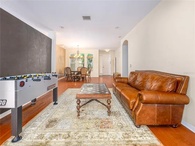 a living room with furniture wooden floor and a table
