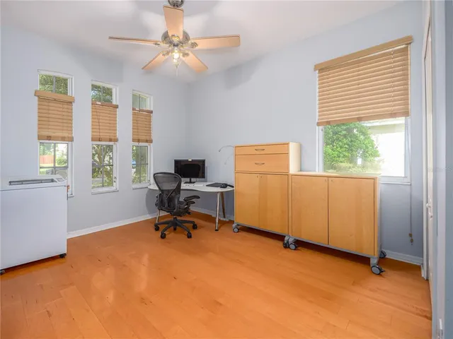 a view of a workspace with furniture and a window