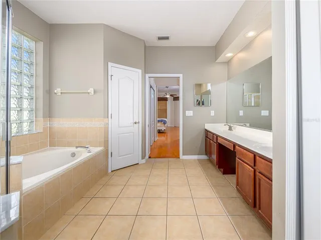 a spacious bathroom with a tub shower and sink