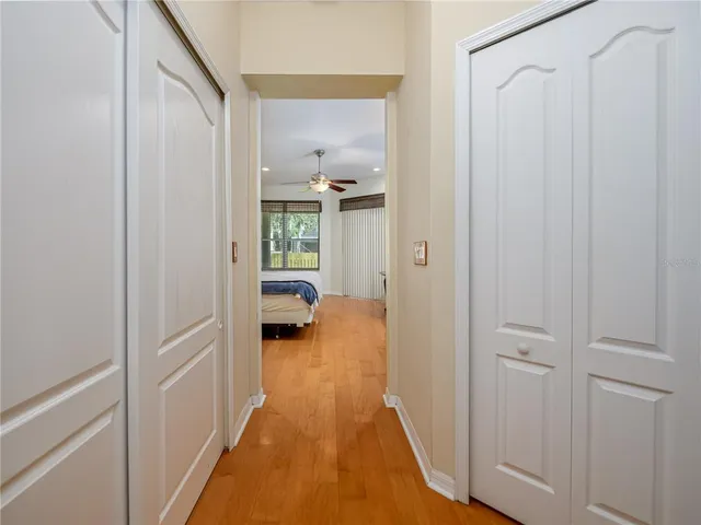 a view of a hallway with a livingroom and a bathroom