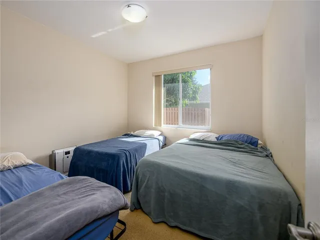 a bedroom with two beds and a window