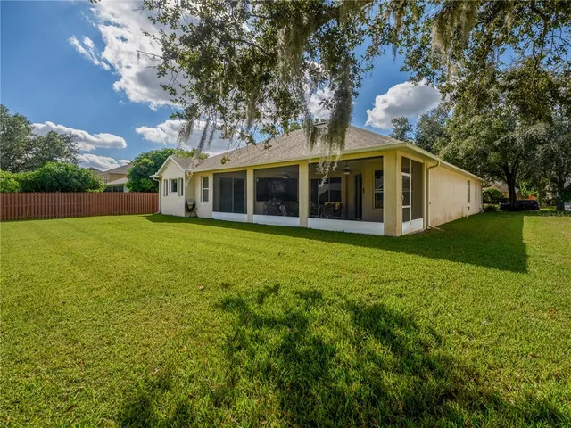 a view of a house with yard and sitting area