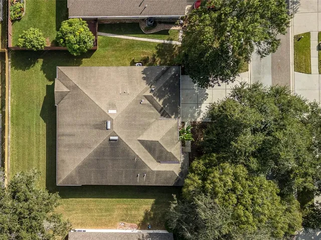 an aerial view of a house with a yard
