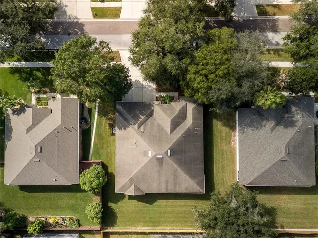 an aerial view of a house with a yard