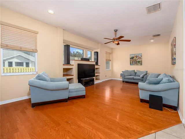 a living room with furniture and a wooden floor