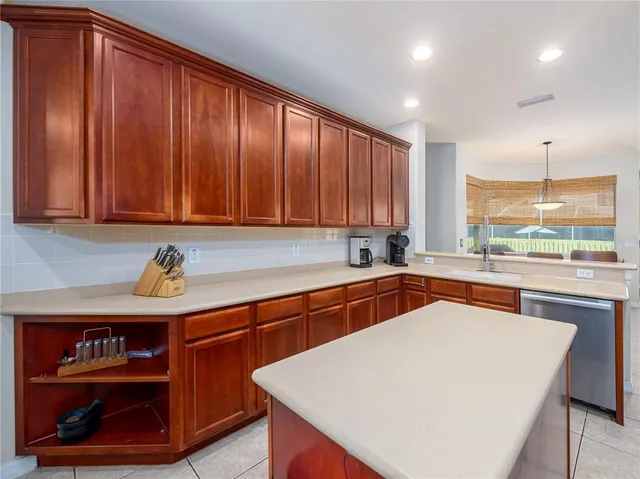 a kitchen with stainless steel appliances granite countertop a sink a stove and a microwave