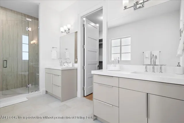 a bathroom with a sink double vanity and a mirror