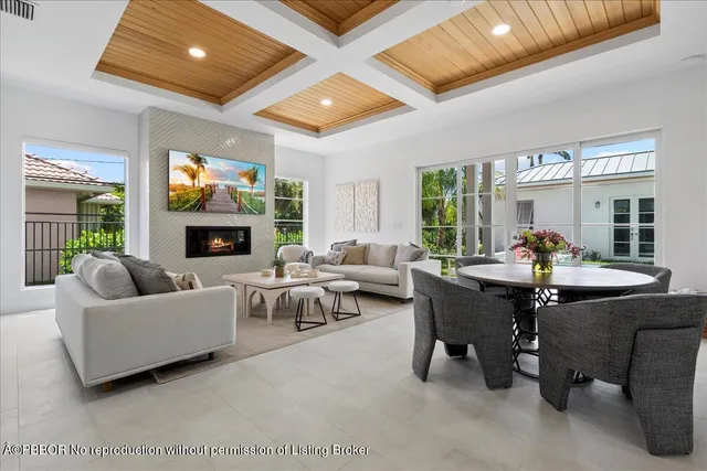 a living room with furniture dining table and a fireplace