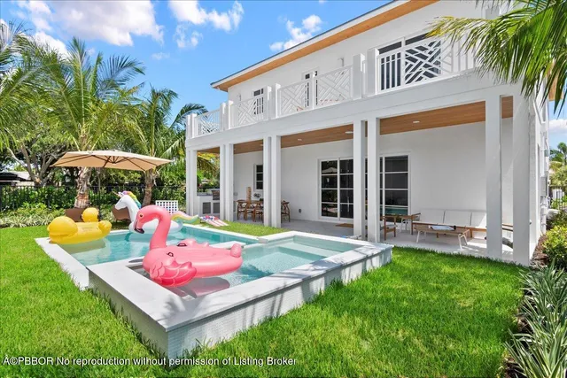 a view of an house with backyard porch and furniture