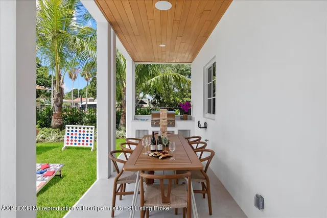 a view of a patio with a table chairs and a backyard
