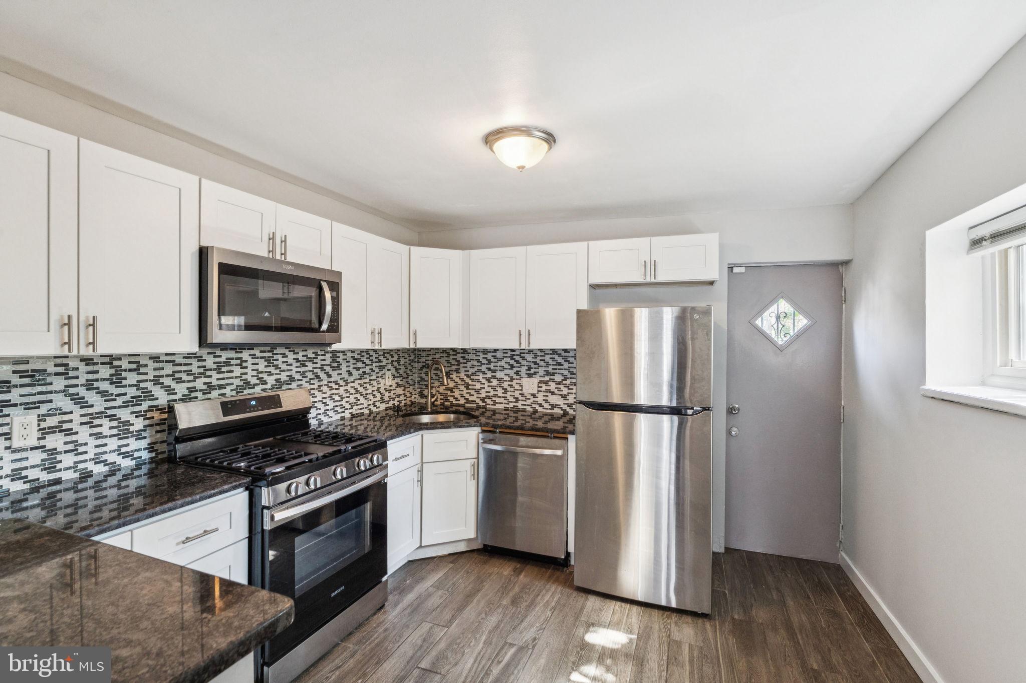 17 South 45th Street Philadelphia, PA 19104 - Photo 7 of 26 a kitchen with a refrigerator stove and microwave