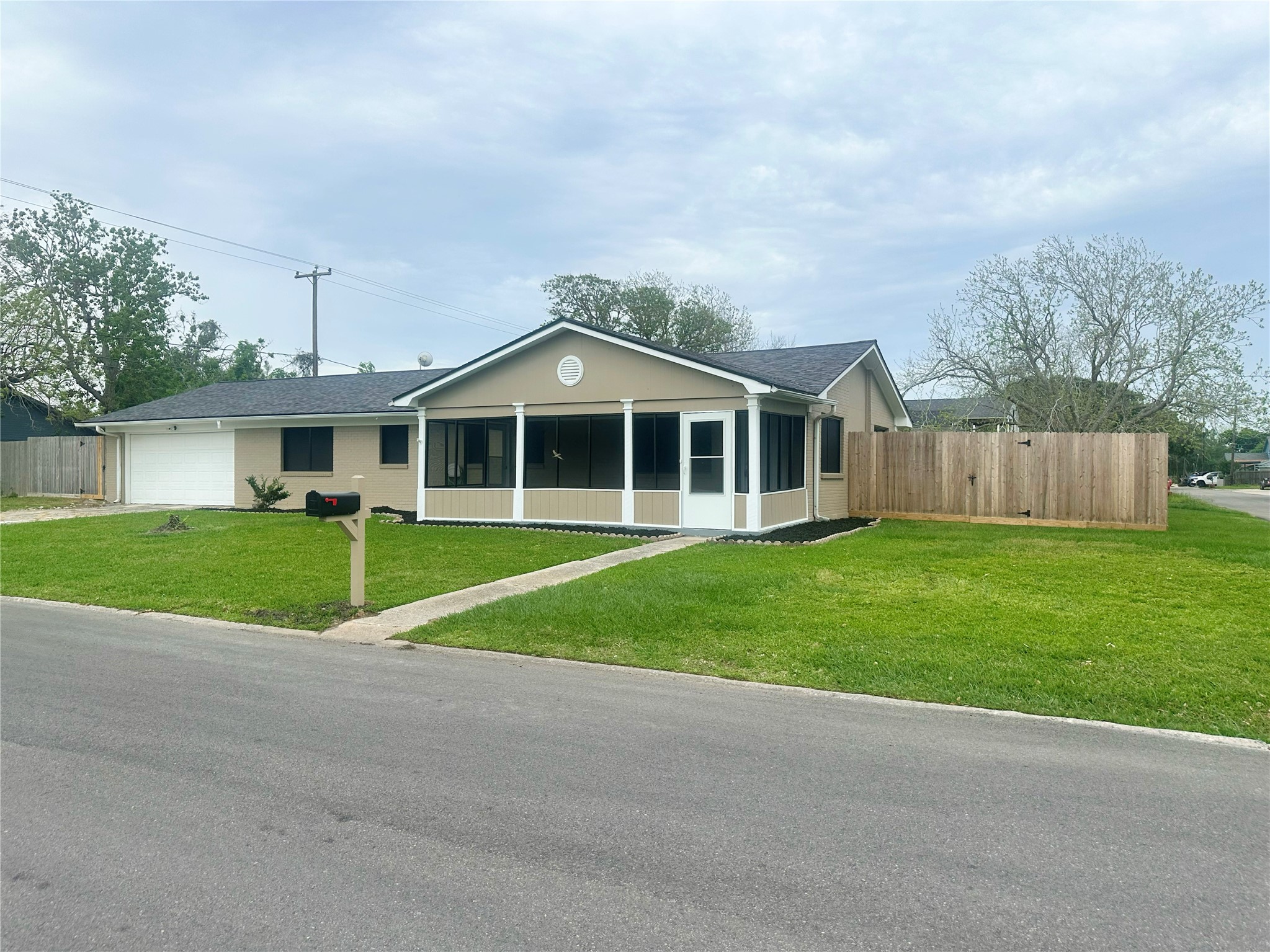 Charming single-story home with a screened porch, attached garage, and a spacious fenced yard. Located on a quiet street, offering ample privacy and curb appeal.
