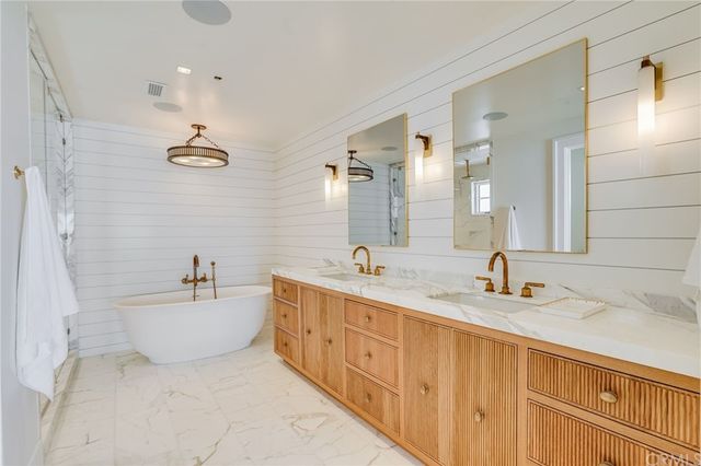a bathroom with a sink vanity granite tub and shower
