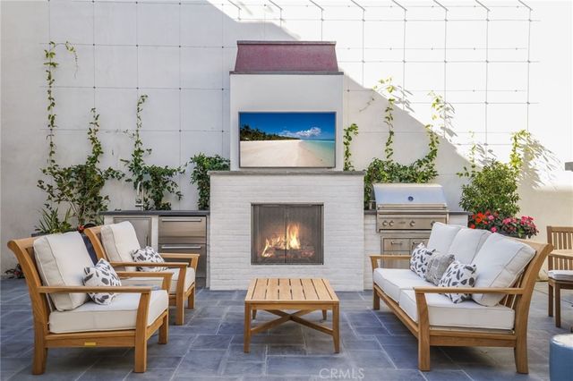 a kitchen with stainless steel appliances kitchen island granite countertop a stove a sink a dining table and chairs with wooden floor