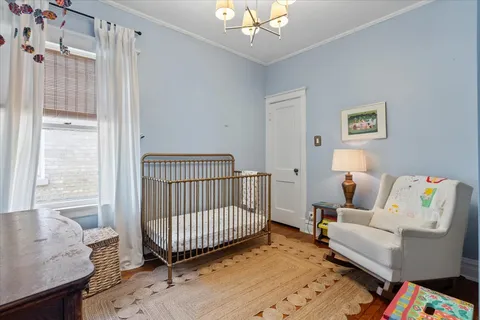 a view of a bedroom with workspace and toys