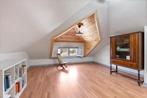 a view of hallway with stairs and wooden floor