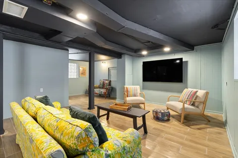 a bedroom with furniture and a wooden floor