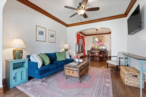a view of a dining room with furniture wooden floor and chandelier
