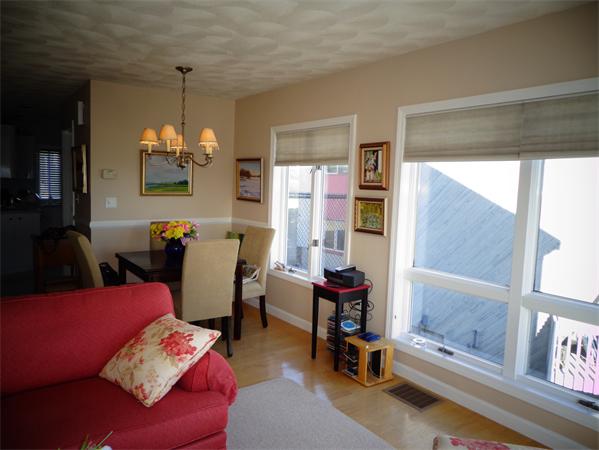 74 Ridge Road, Unit 74 Revere, MA 02151 - Photo 4 of 16 a living room with furniture and a chandelier