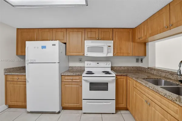 a white refrigerator freezer sitting in a kitchen