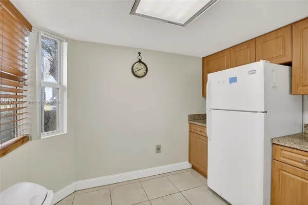 a white refrigerator freezer and a dishwasher sitting in a kitchen