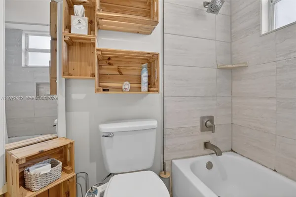 a bathroom with a toilet and a bathtub