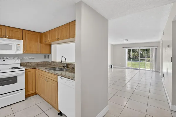 a kitchen with a stove a sink and a refrigerator