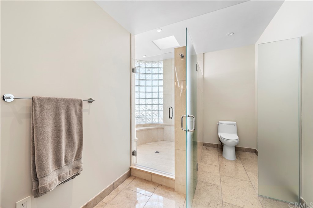 818 Hillcrest Drive Laguna Beach, CA 92651 - Photo 29 of 43 Large marble shower with two shower heads, seating and a view.