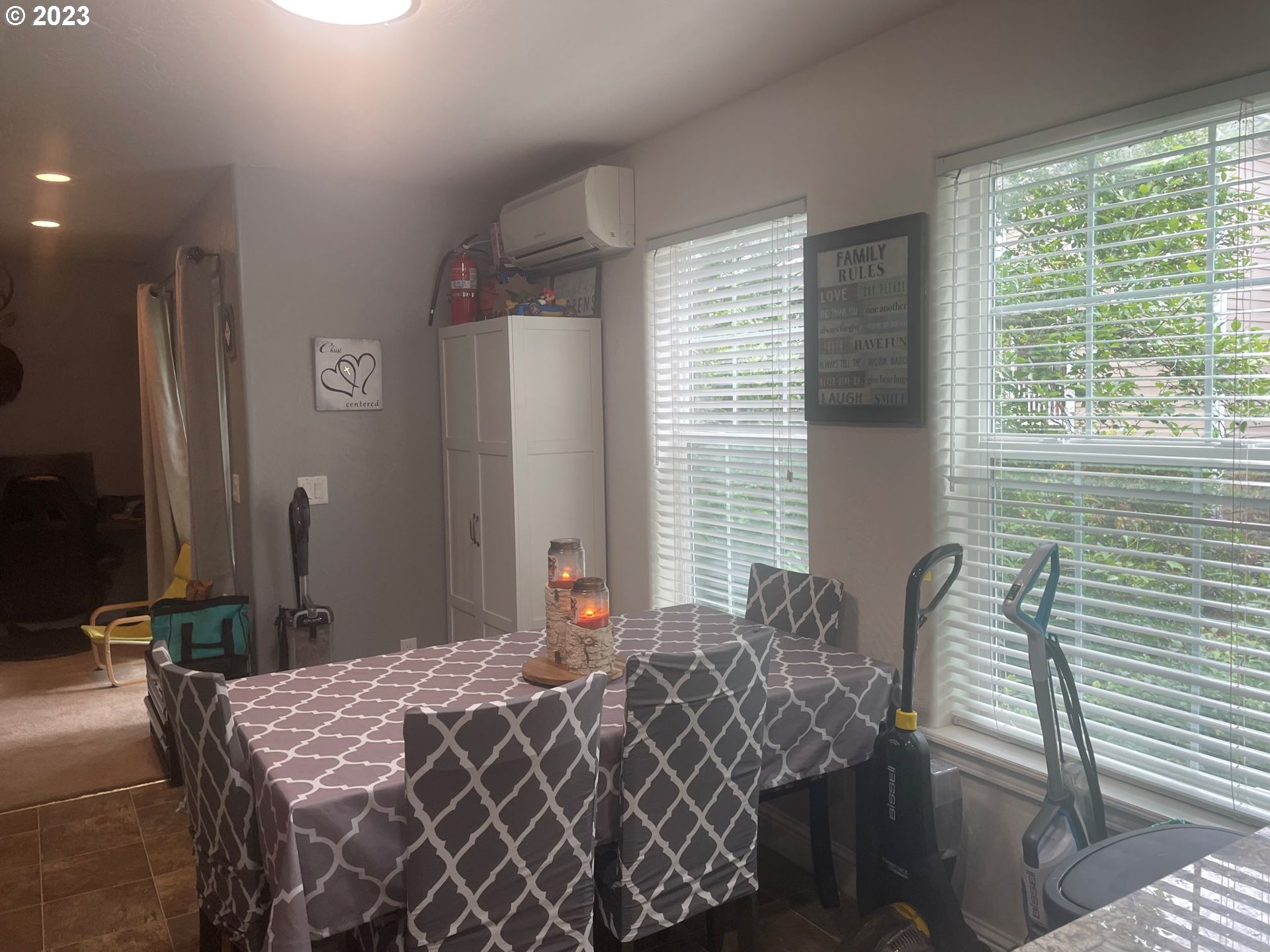 819 Easy Street, Unit 1 Brookings, OR 97415 - Photo 7 of 25 a bedroom with a bed and a chandelier