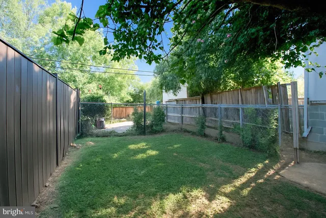 a white house that has tree in front of it