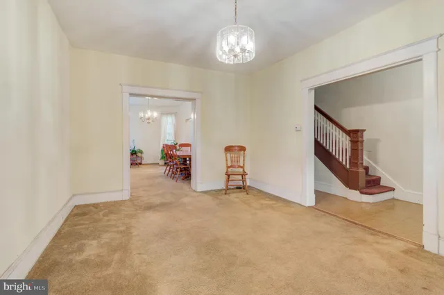 a view of a livingroom with furniture and staircase