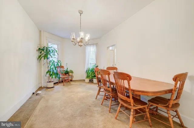 a view of a dining room with furniture and a chandelier