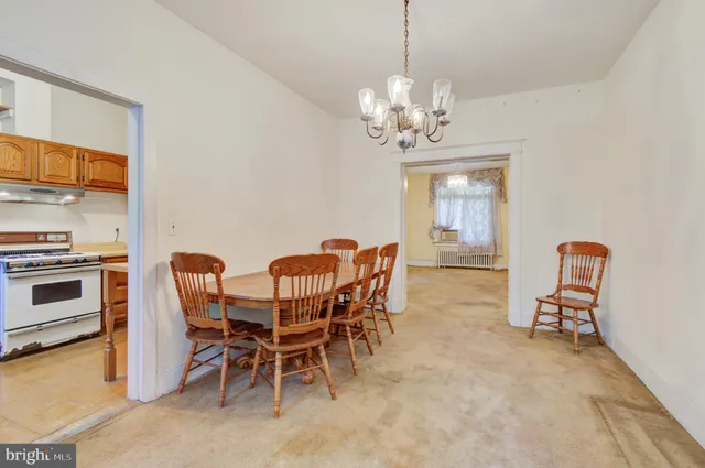 a view of a dining room with furniture and chandelier
