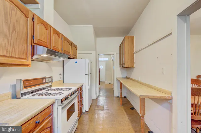 a kitchen with a stove and a white cabinets