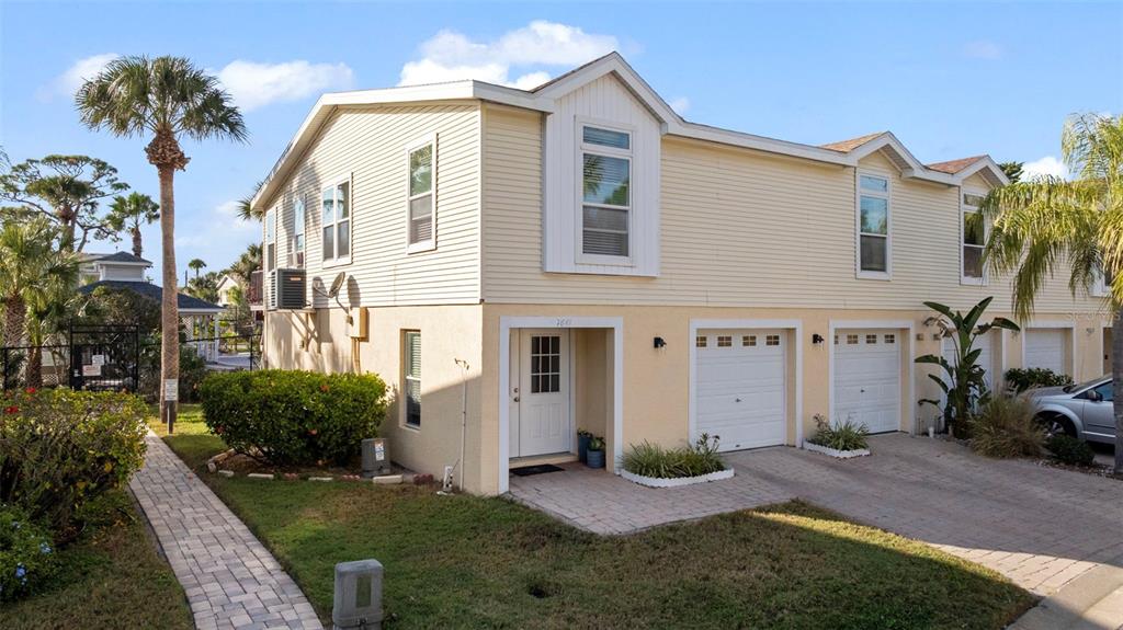 7641 Sailwinds Pass Port Richey, FL 34668 - Photo 1 of 59 a front view of a house with a yard
