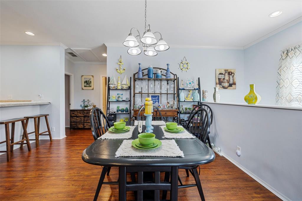 7641 Sailwinds Pass Port Richey, FL 34668 - Photo 11 of 59 a view of a dining room with furniture and wooden floor