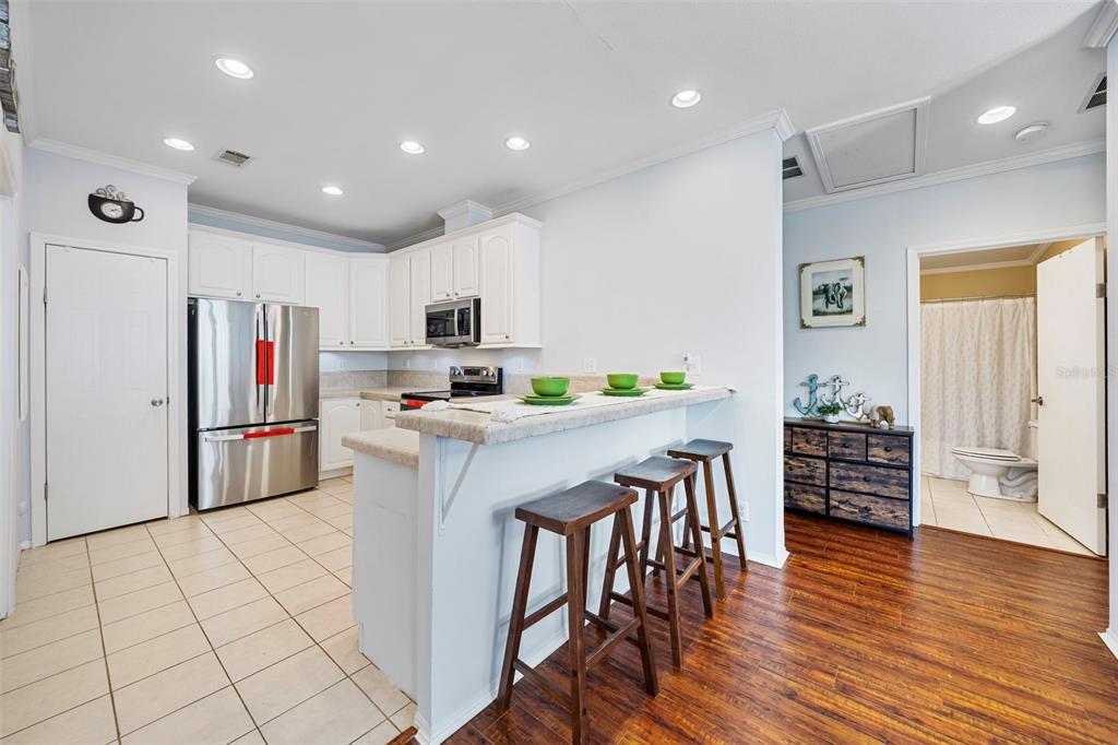 7641 Sailwinds Pass Port Richey, FL 34668 - Photo 13 of 59 a kitchen with stainless steel appliances kitchen island granite countertop a refrigerator and a stove top oven