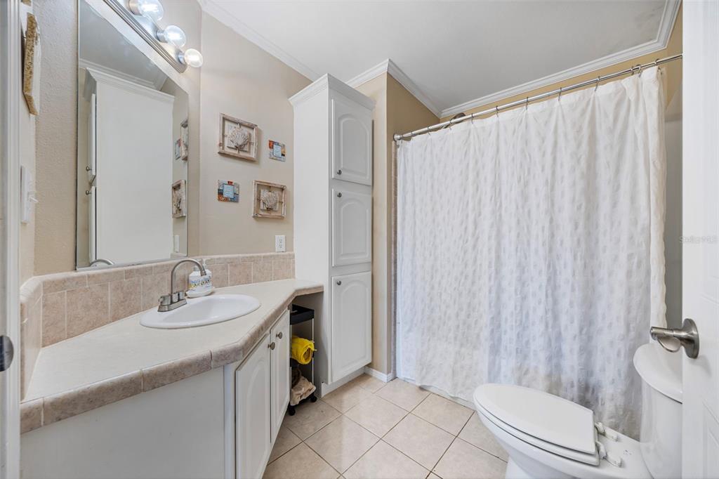 7641 Sailwinds Pass Port Richey, FL 34668 - Photo 21 of 59 a bathroom with a sink a toilet and shower