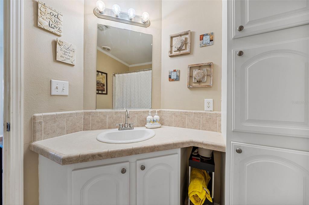 7641 Sailwinds Pass Port Richey, FL 34668 - Photo 22 of 59 a bathroom with a granite countertop sink and a mirror