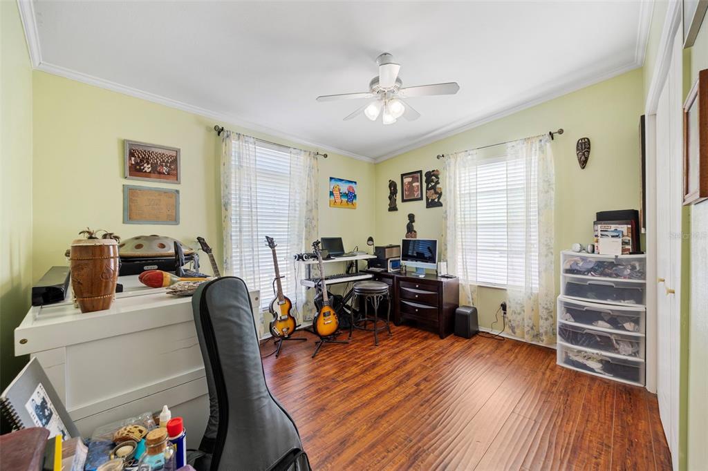 7641 Sailwinds Pass Port Richey, FL 34668 - Photo 23 of 59 a view of a workspace with furniture and wooden floor