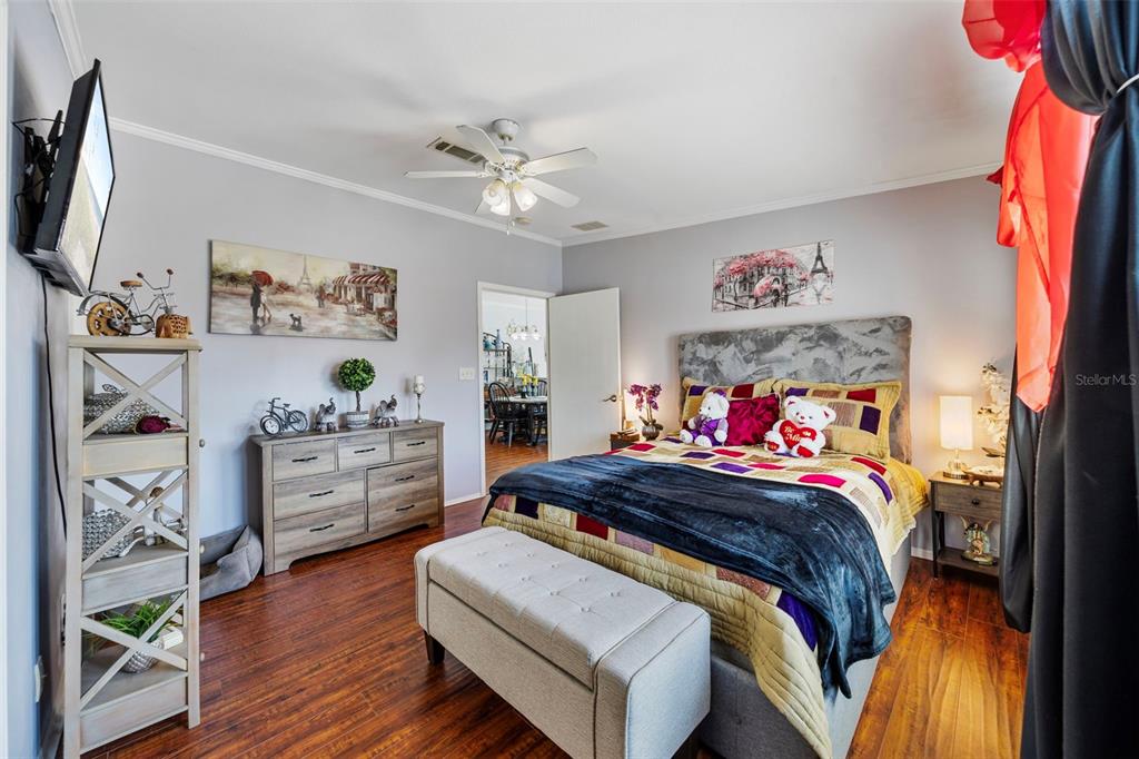 7641 Sailwinds Pass Port Richey, FL 34668 - Photo 25 of 59 a bedroom with a bed and a flat screen tv