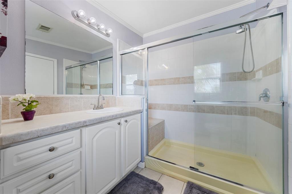 7641 Sailwinds Pass Port Richey, FL 34668 - Photo 27 of 59 a bathroom with a shower sink and mirror